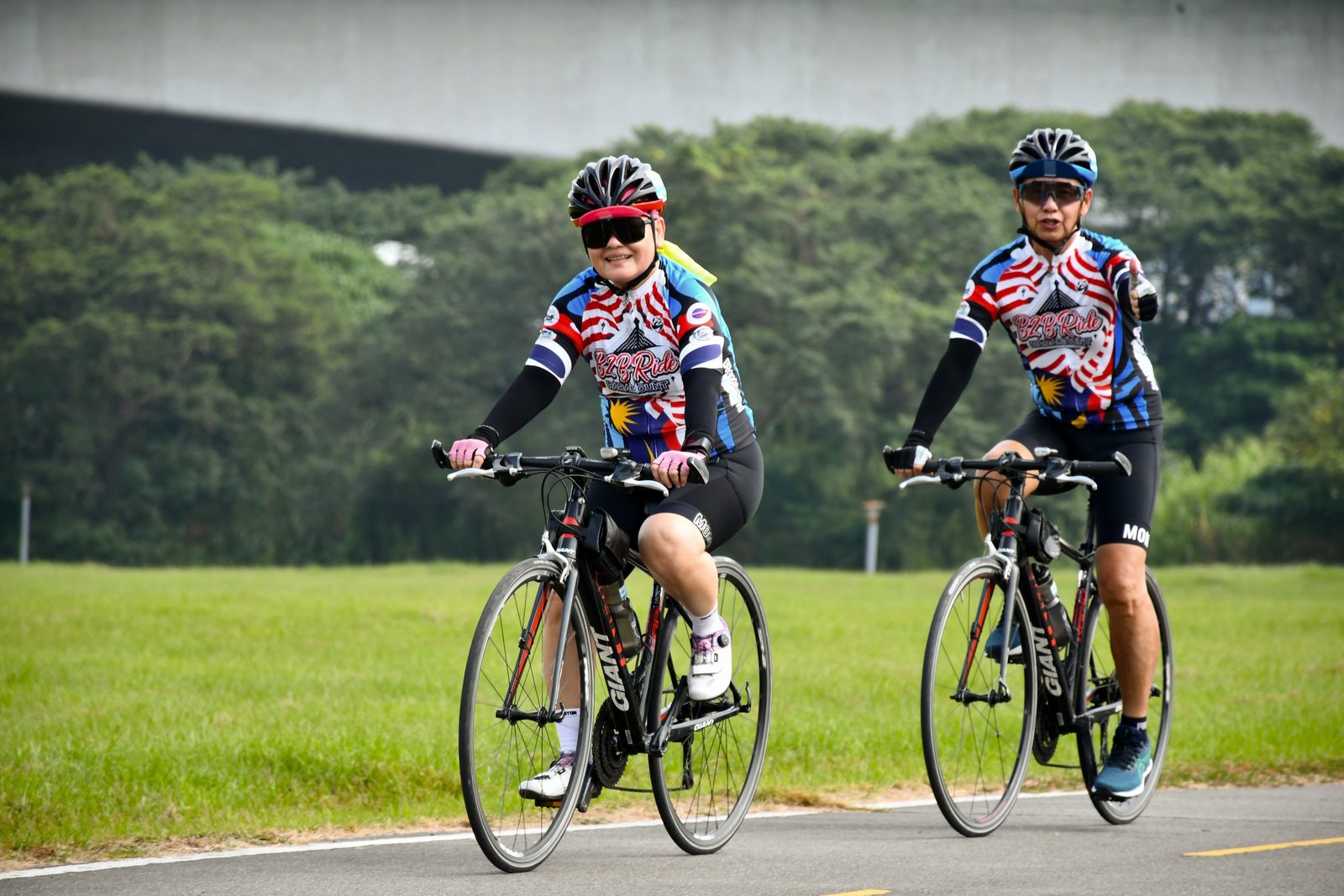 Two riders in matching jerseys riding side by side