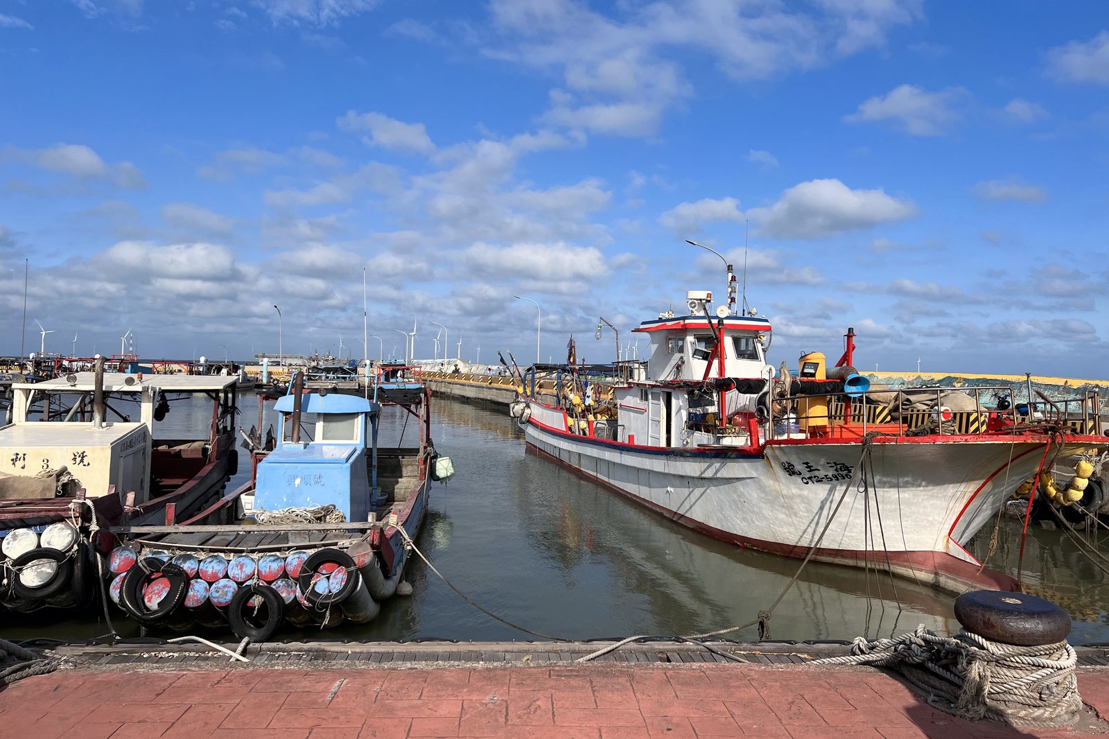 Fishing boats moored in a small harbor
