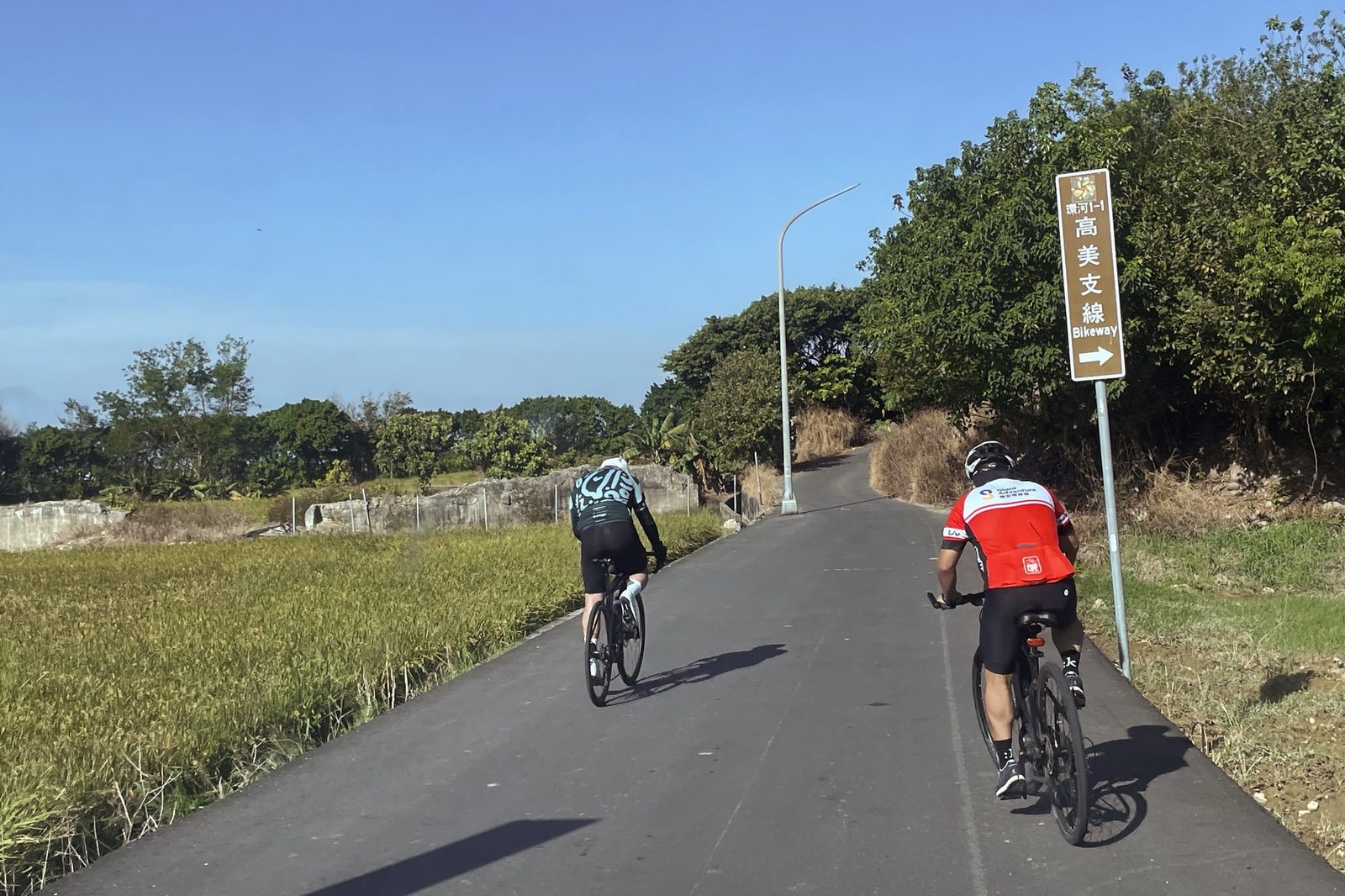 Riders following the Bikeway sign along the route
