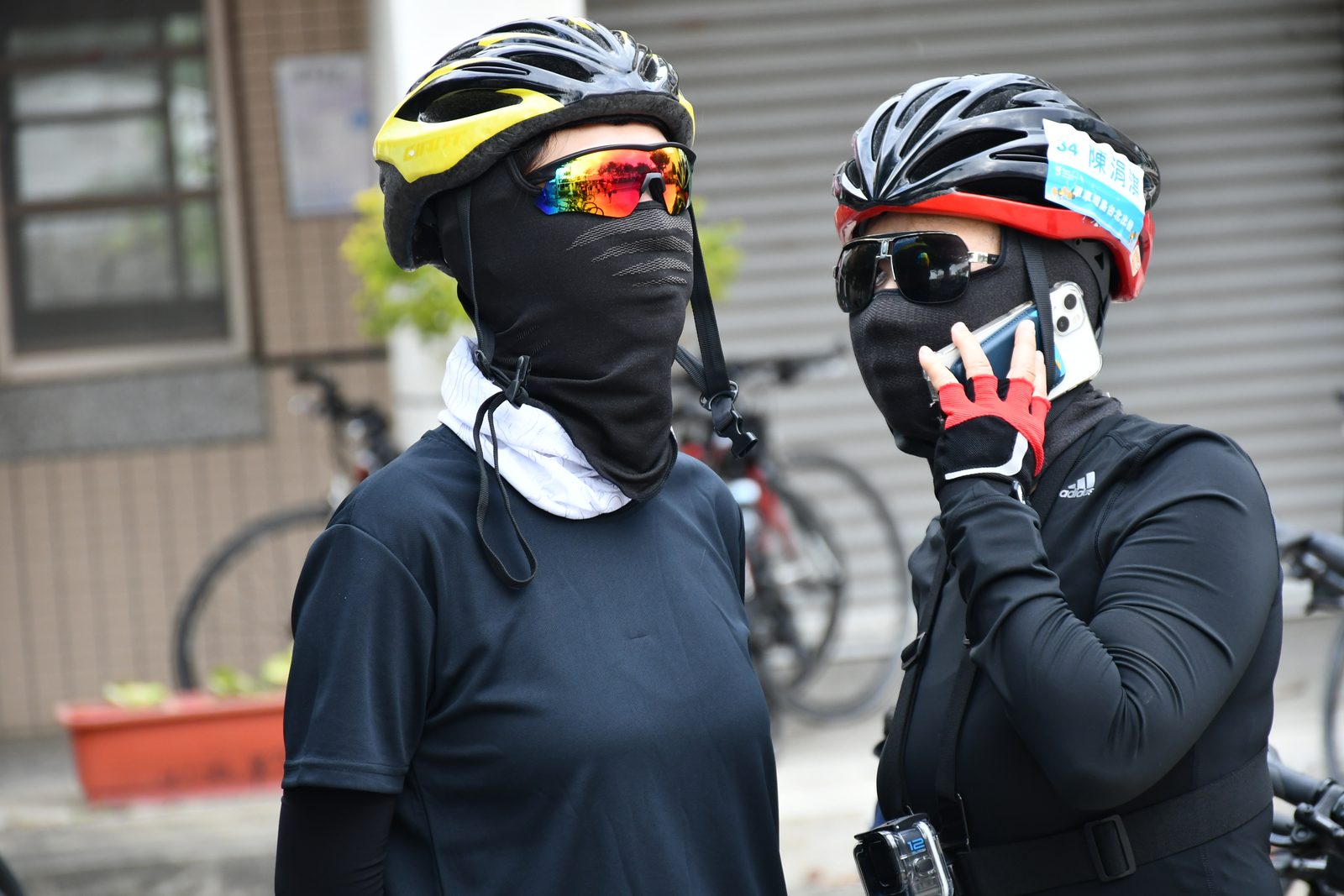 Two riders bundled up in face masks at a stop