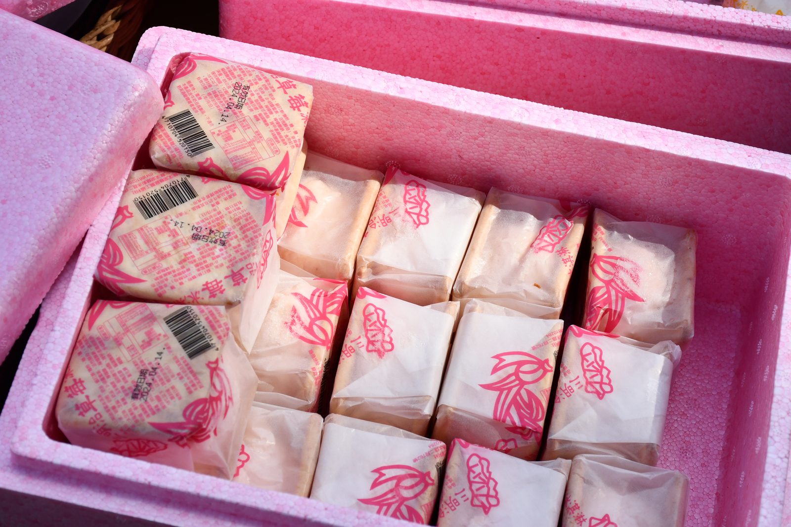 A cooler box of wrapped rice cakes for the road