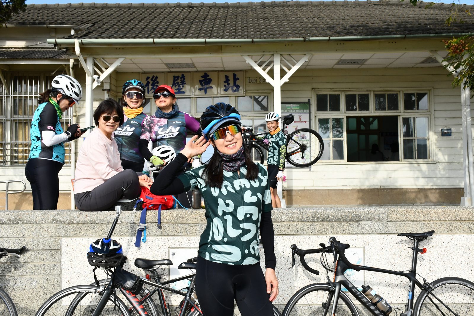 A small group posed at the historic Houbi Station