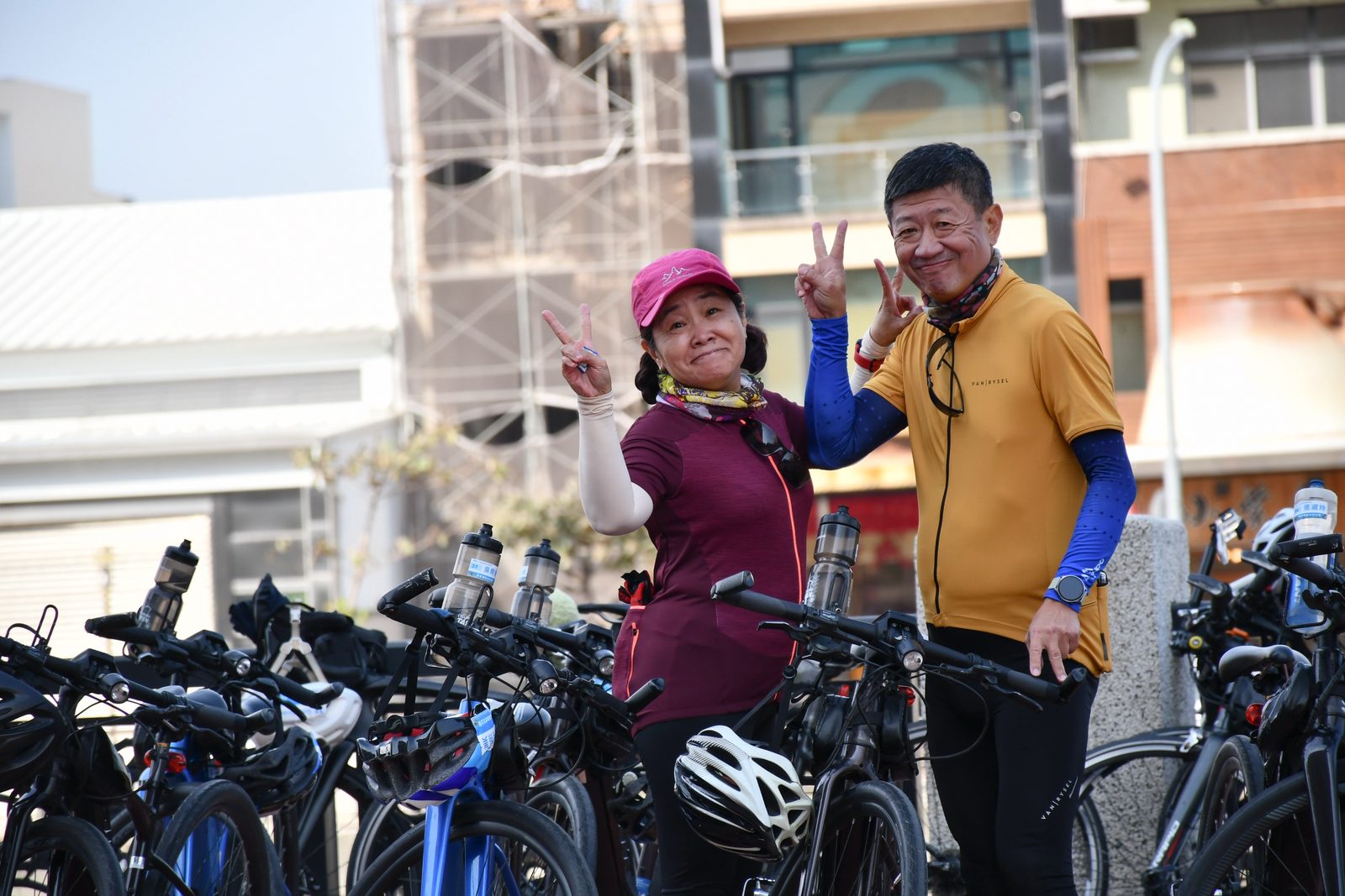Peace signs in front of a half-finished building