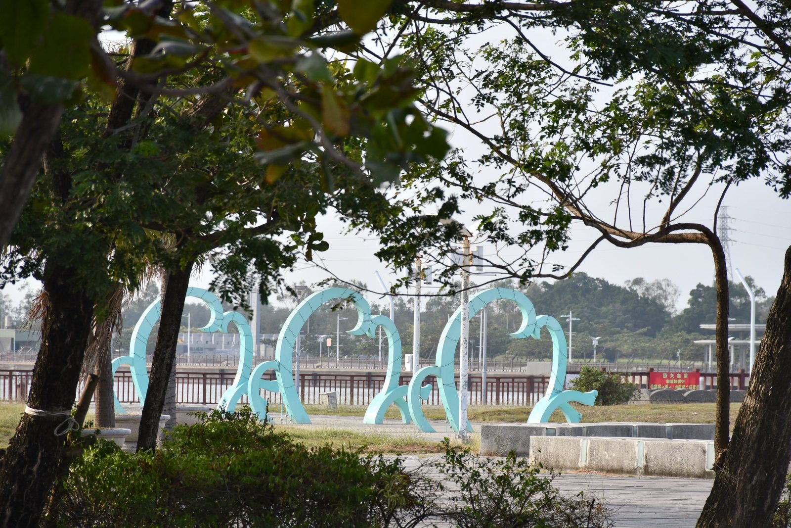 Wave-shaped sculptures in a riverside park
