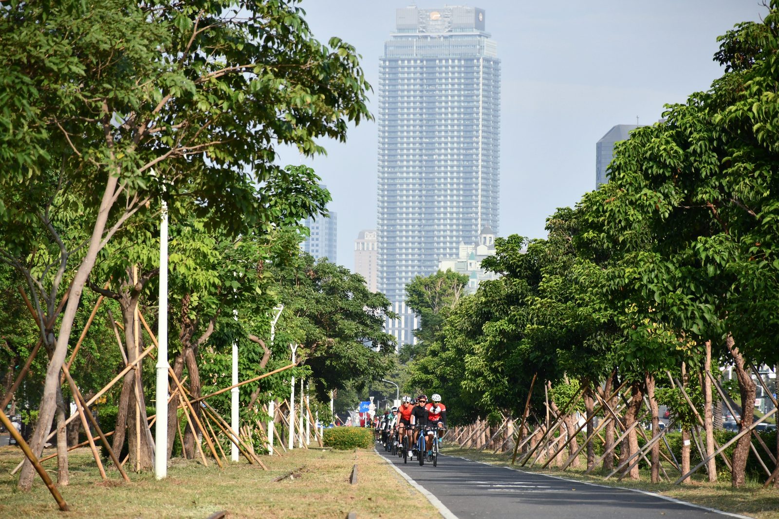 Riders passing under a skyscraper on the way out of the city