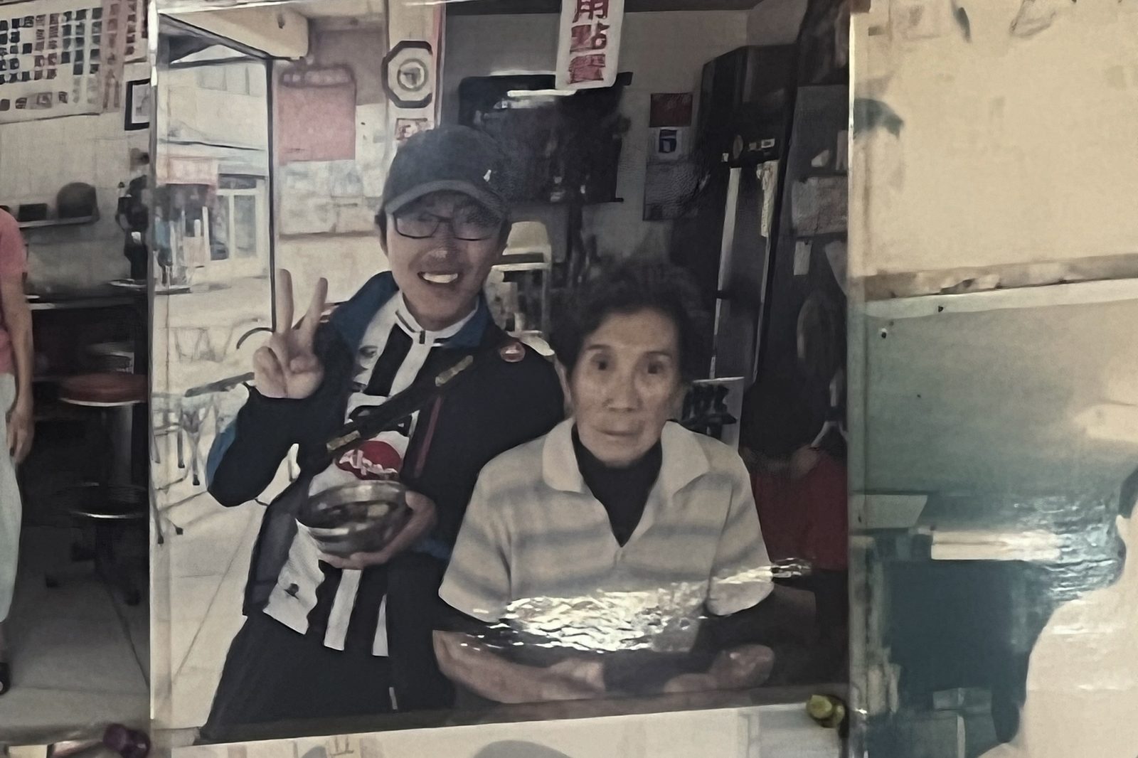 A warped mirror selfie with the shaved ice shop owner