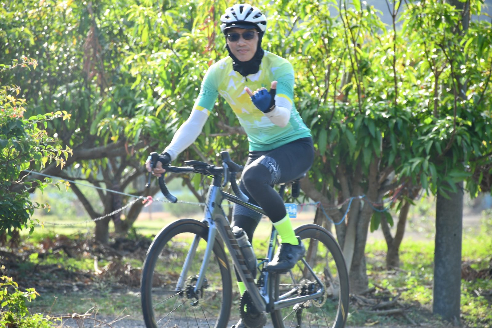 A one-legged trick pose in the mango orchard
