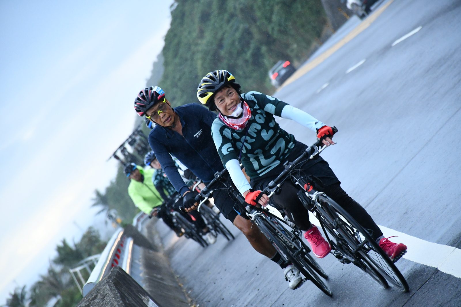 Grinning through the rain-soaked stretch