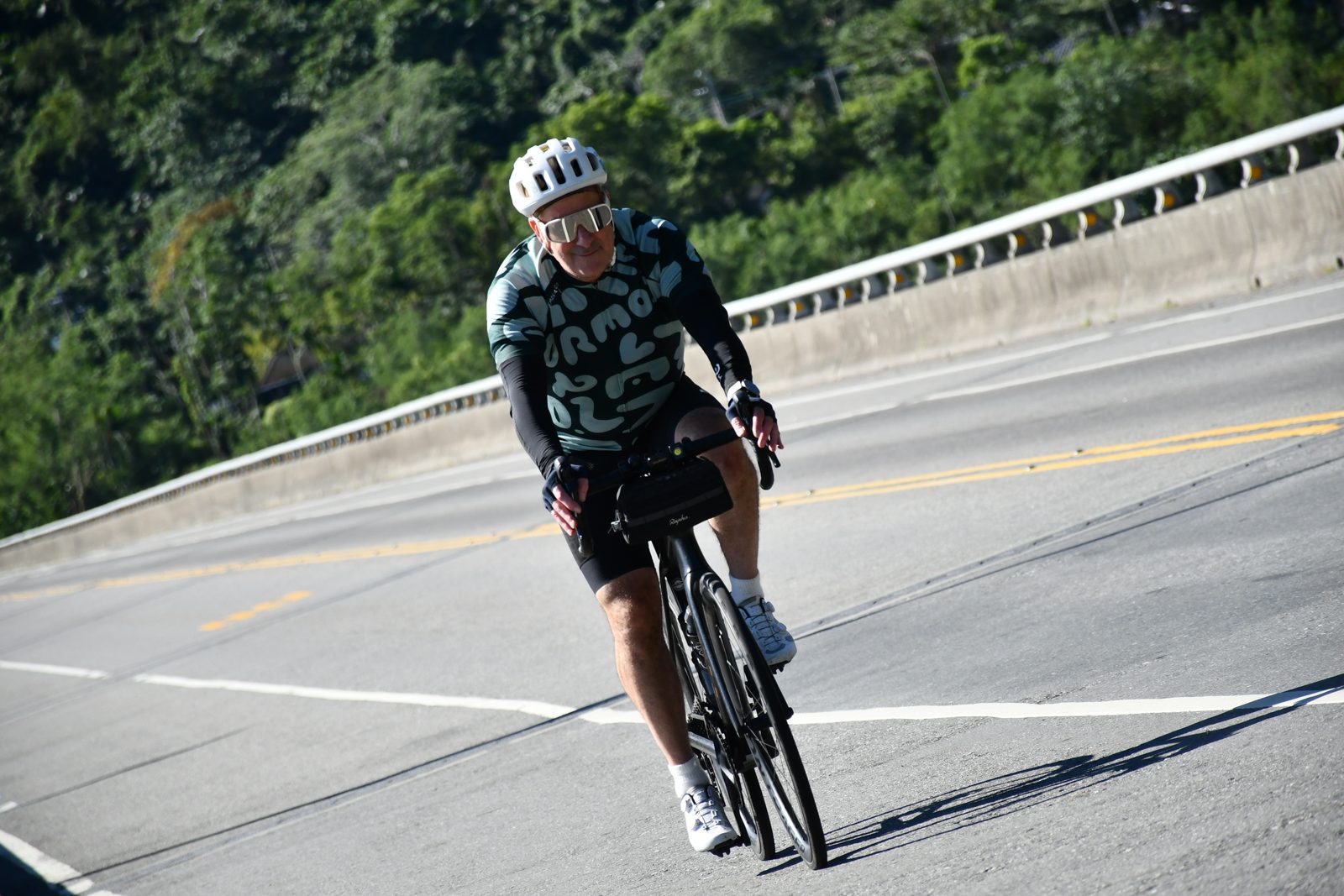 Riding across the bridge in the morning sun