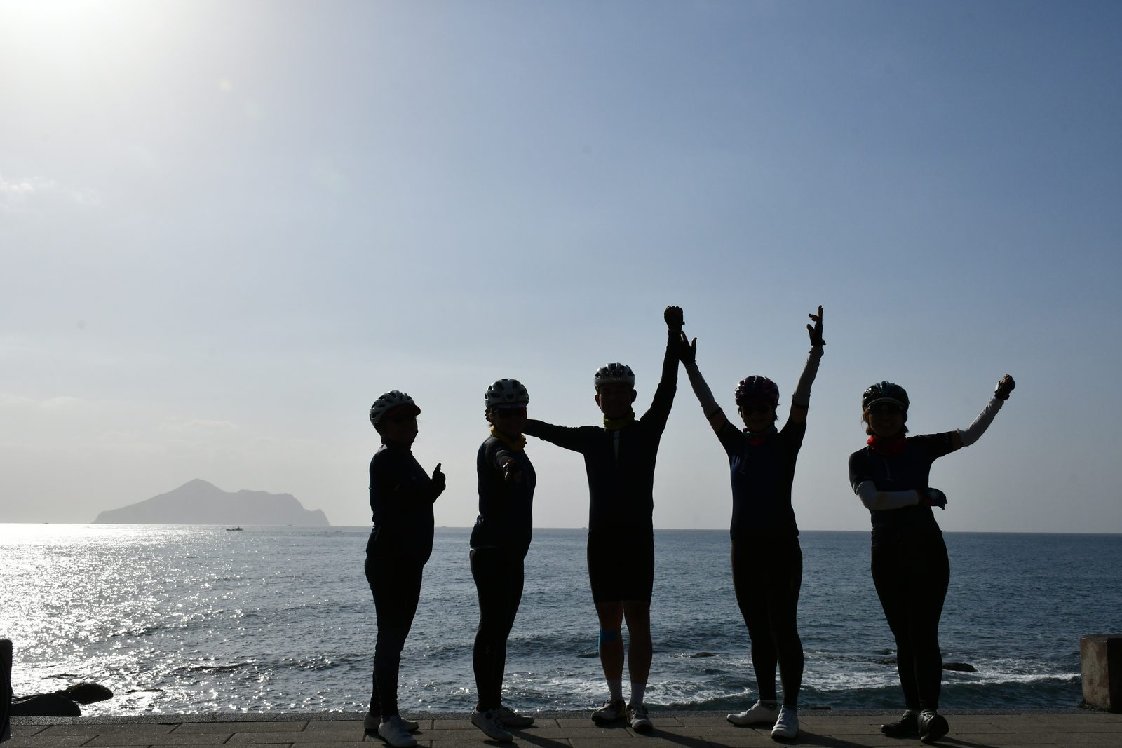 Hands raised together with Turtle Island behind