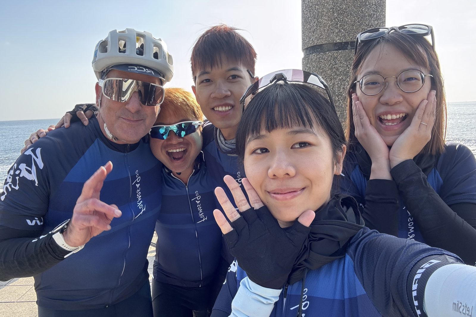 A group selfie with the ocean behind